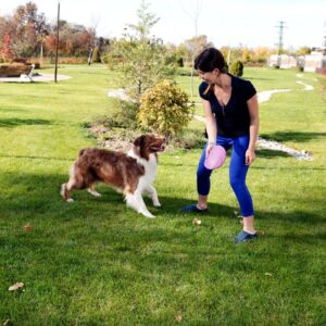 woman playing with dog